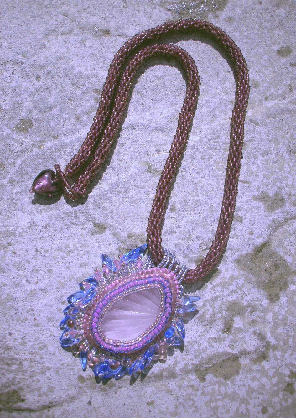 Purple sea glass pendant with sunray effect on glass